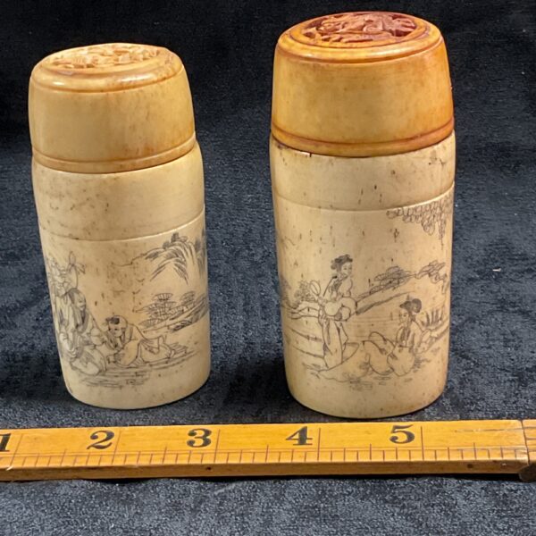 Vintage Chinese bone pots with detailed scrimshaw carvings.