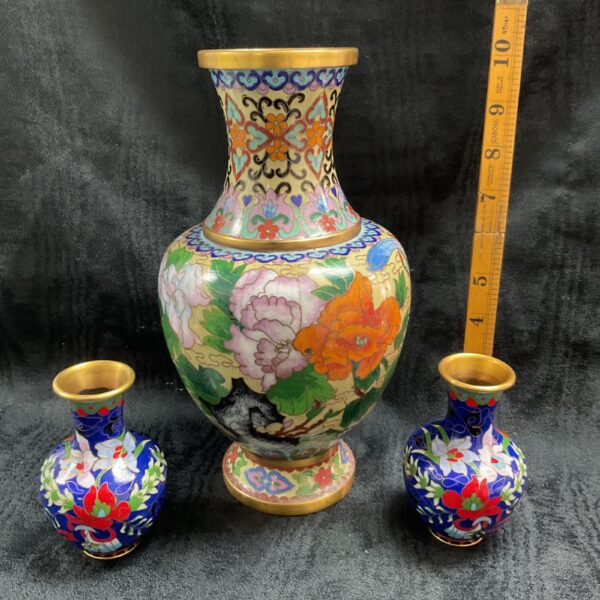 Antique Chinese cloisonne vases with vibrant floral enamel designs.