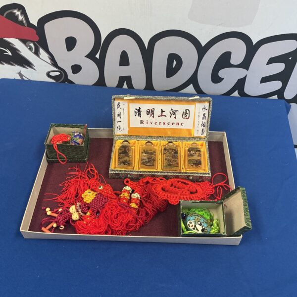 Chinese curios collection featuring miniature paintings and silk tassels.