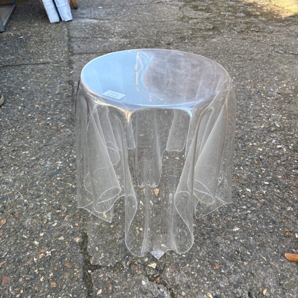 Clear acrylic coffee table, modern minimalist design.