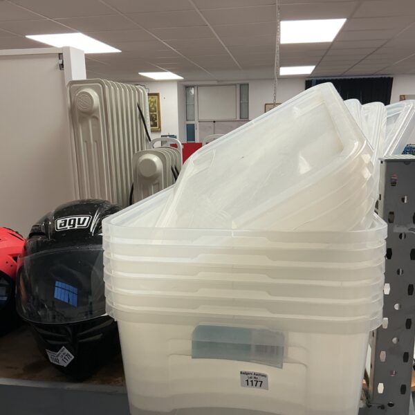 Six clear plastic storage boxes with lids for home organisation.