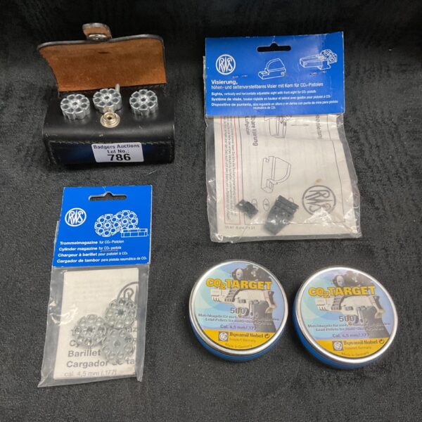 Vintage lot of CO2 magazines, airgun pellets, and accessories.