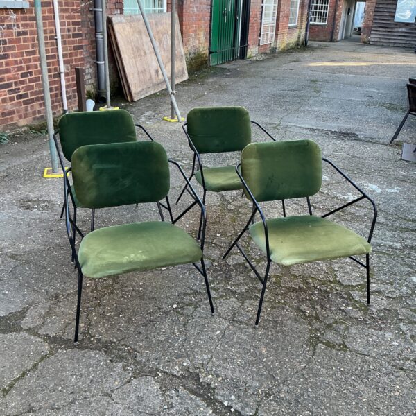 Set of four green velvet Cosco Stylaire chairs in a vintage setting.