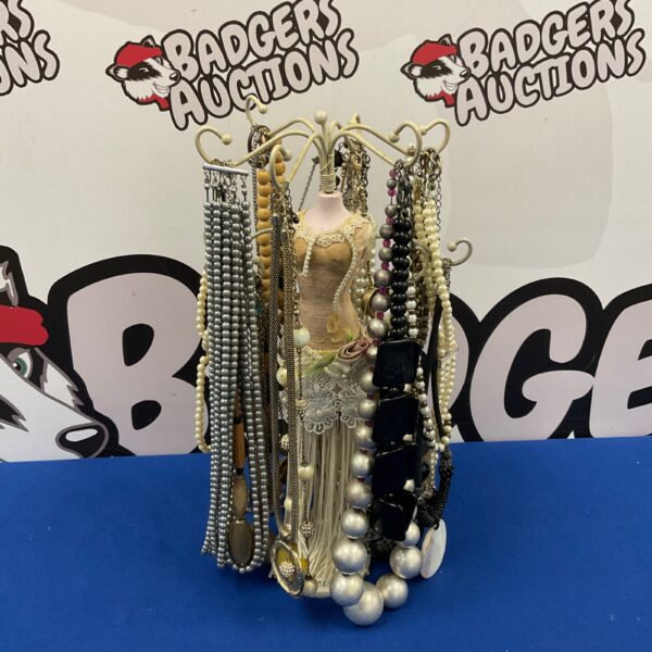 Vintage costume jewellery display mannequin with necklaces.