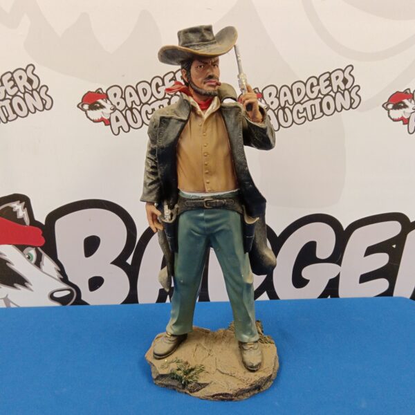 Detailed resin cowboy sculpture with pistol drawn, Western art collectible.