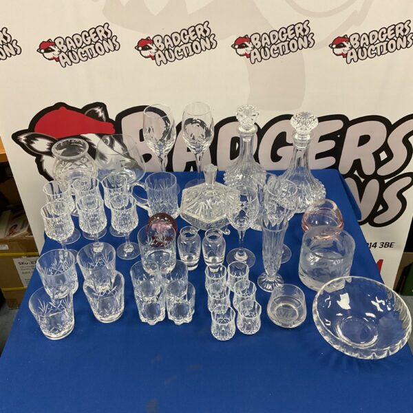 Elegant crystal decanter set with cut glass whiskey tumblers.
