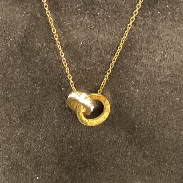 Gold plated crystal Roman numeral pendant necklace on a chain.