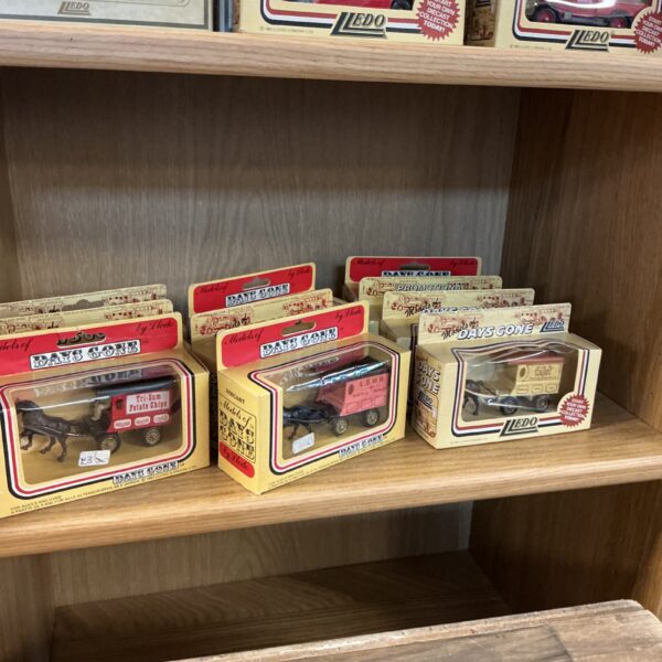 Days Gone diecast model cars in clear display cases.