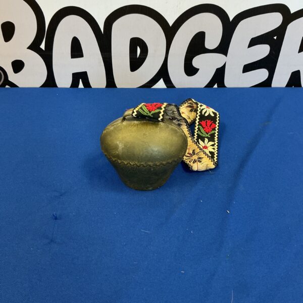 Vintage decorative cow bell with weathered patina.