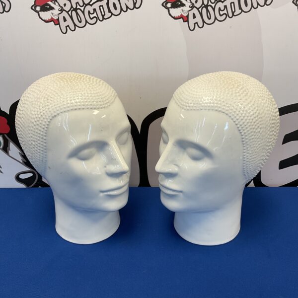 Pair of vintage white ceramic delft mannequin heads for display.