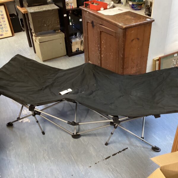 Deluxe camp bed folded for easy storage and transport.