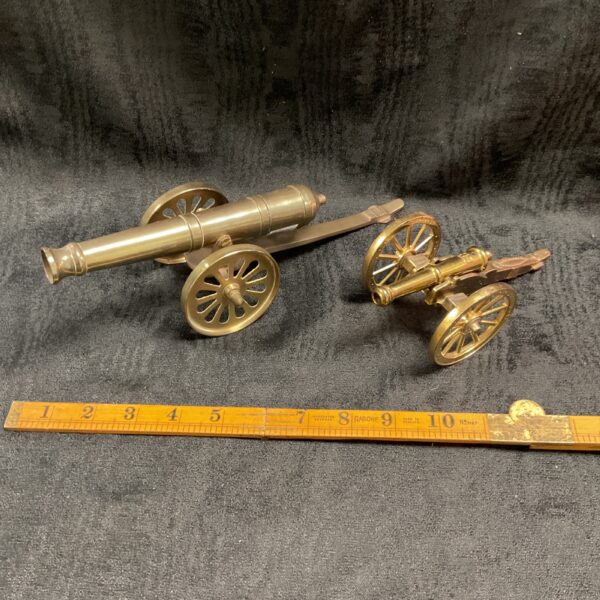 Pair of vintage metal desk top cannons for display.