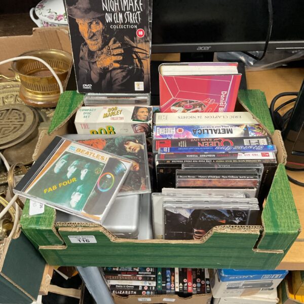 Mixed lot of disk sets, DVDs, and CDs for home entertainment.