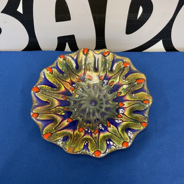 Front view of a colourful Don Andrick enamelled dish.