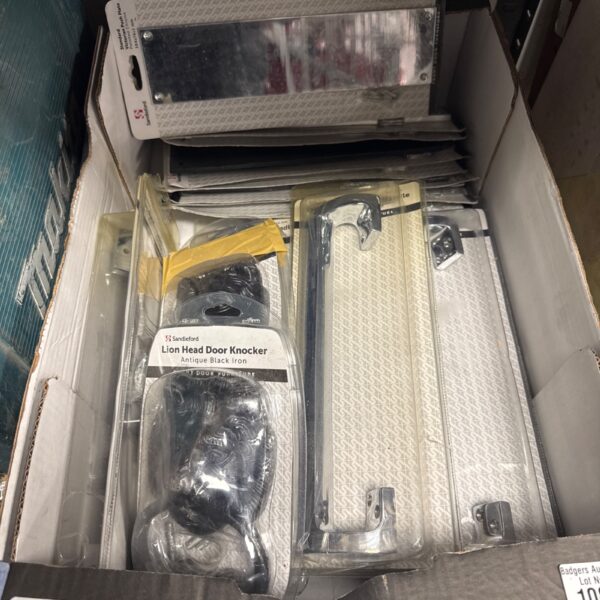Assorted new door furniture lot in original packaging.