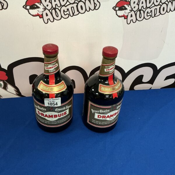 Two vintage bottles of Drambuie Scottish whisky liqueur.