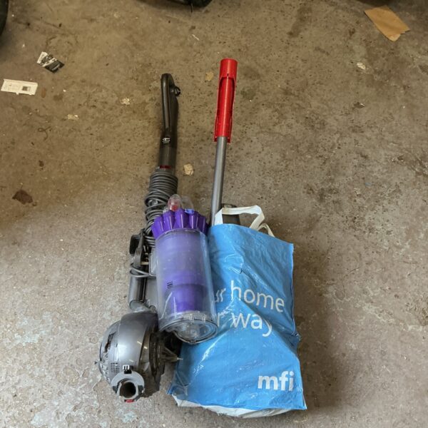 Dyson vacuum cleaner with detachable components, presented for auction.