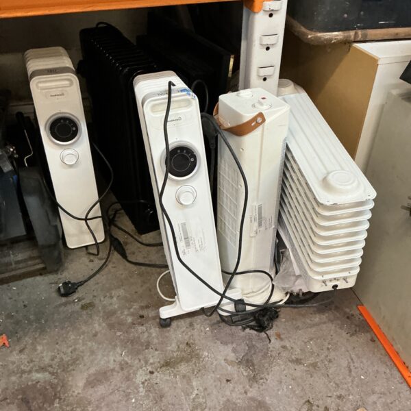 Lot of used electric heaters, oil-filled radiators for winter warmth.