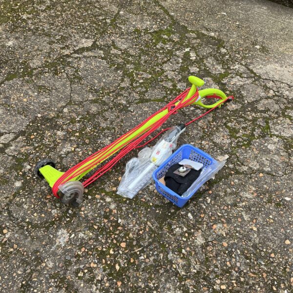 Used electric lawn edger with attachments for garden landscaping.
