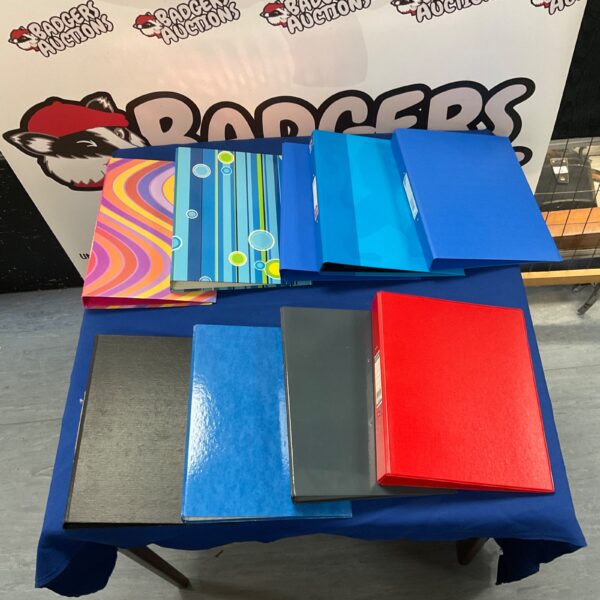 Assorted empty ring binders for document storage.