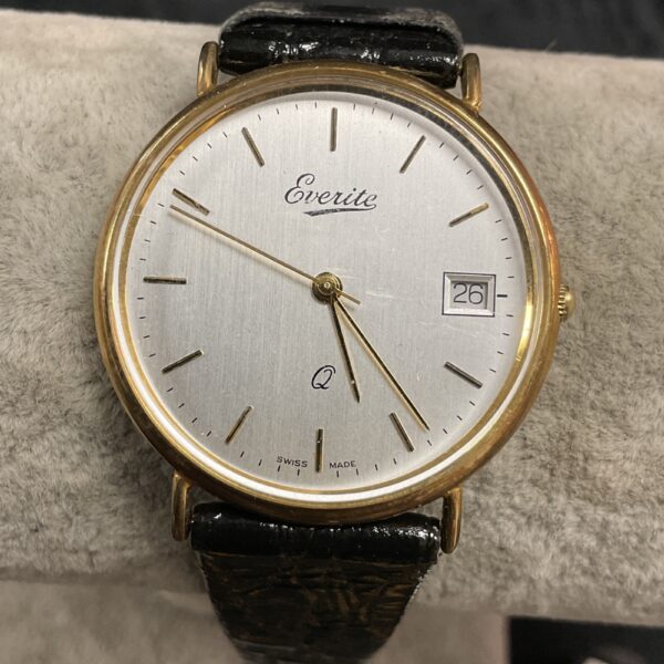 Close-up of the silver dial on a vintage Everite 9ct gold watch.