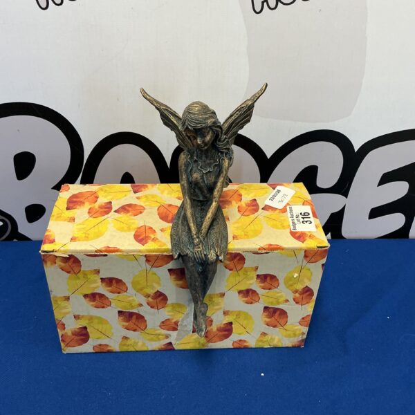 Detailed resin fairy figurine in original packaging.