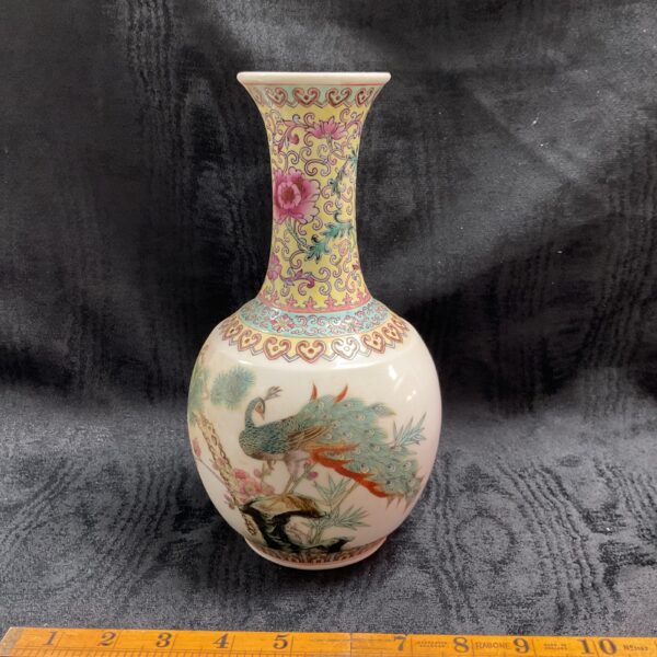 Antique Famile Rose porcelain vase with a peacock design.