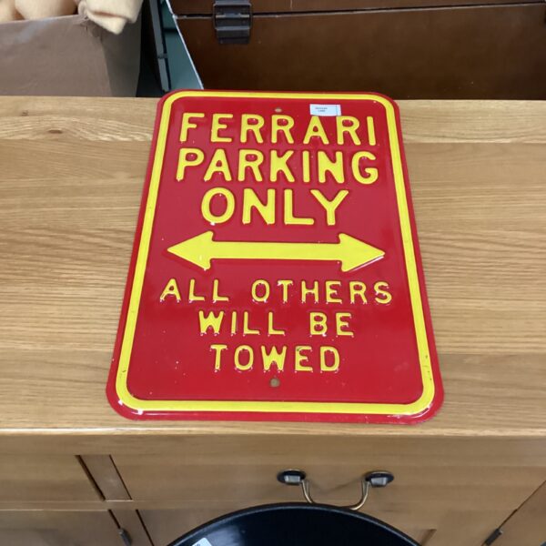Vintage Ferrari parking sign for car enthusiasts and collectors.
