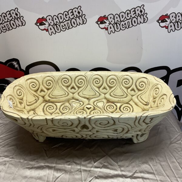 Large patterned fibreglass planter trough for garden display.