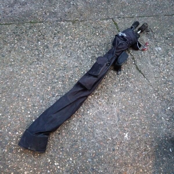 Pair of used fire juggling sticks with protective sleeves.