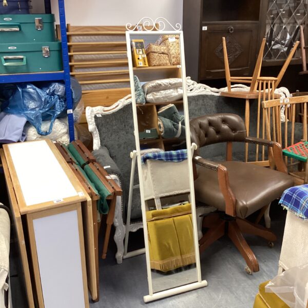 Vintage metal framed floor standing mirror in a room setting.