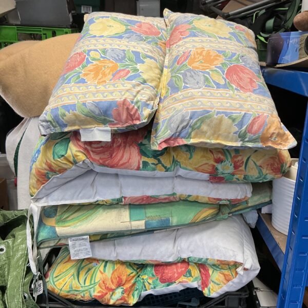 Vibrant floral sunlounger cushions for garden or patio use.