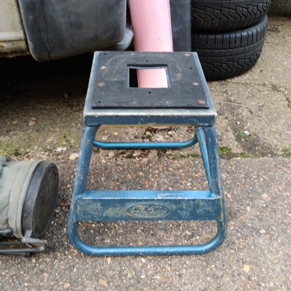 Blue Fly Racing motorcycle stand for rear wheel maintenance.
