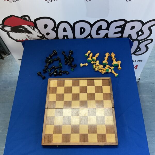 Fold-up chess set with chessboard and pieces displayed.