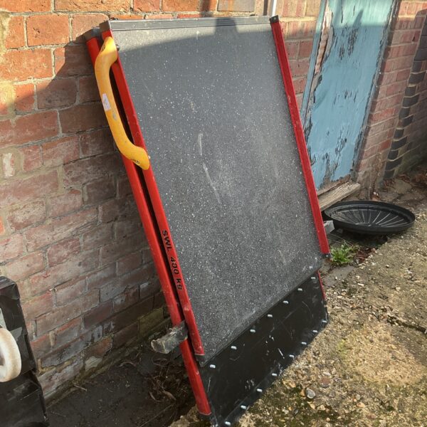 Red folding access ramp with 400kg Safe Working Load.