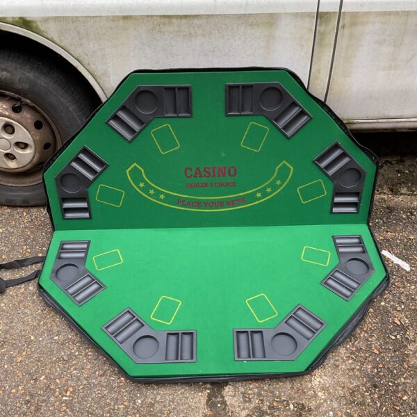 Green felt folding poker table for card games and casino nights.