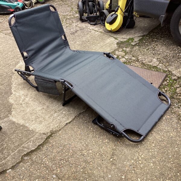 Used folding sunlounger in a garden setting.