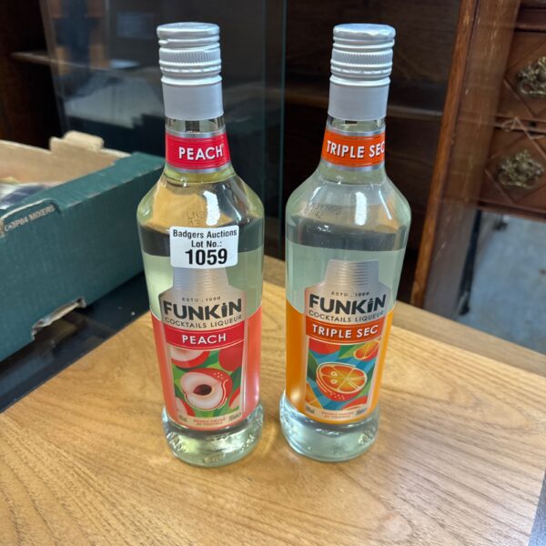 Two bottles of Funks peach cocktail liqueur for mixing drinks.