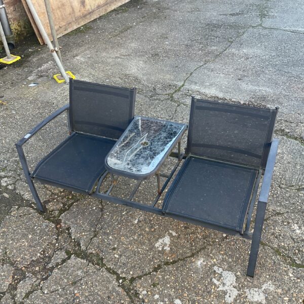 Vintage garden chair set with cracked glass table top.