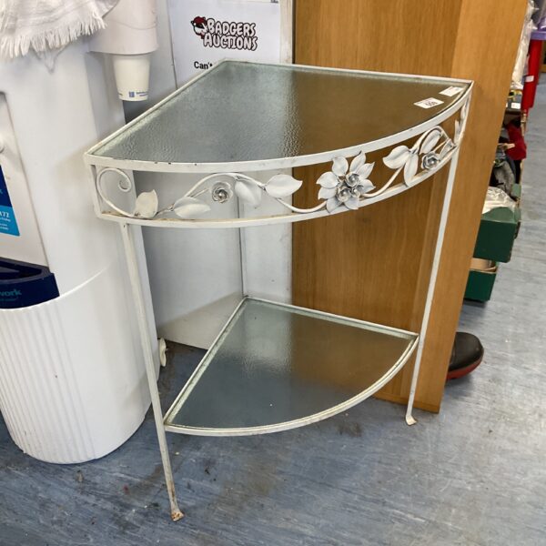 Decorative metal garden corner table with glass top.
