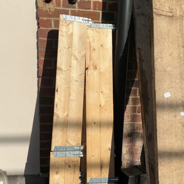 Two wooden sections for garden flower beds with metal bracing.