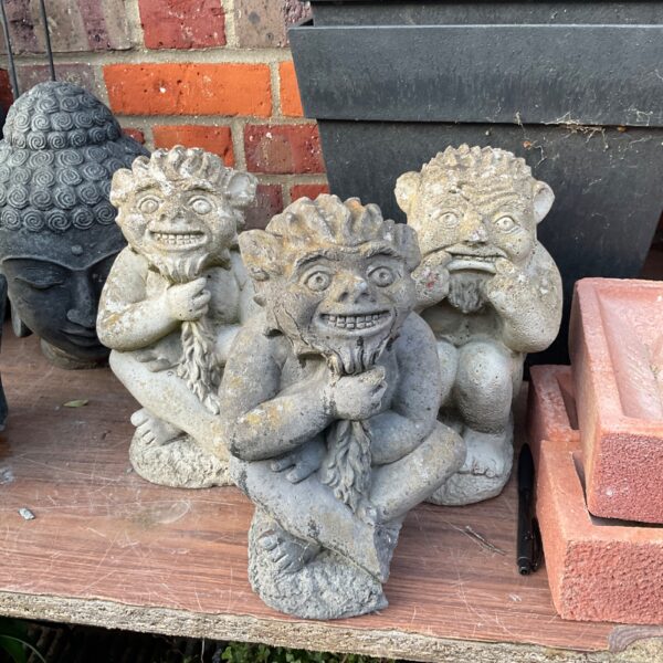 Lot of three vintage cast stone garden imp ornaments.