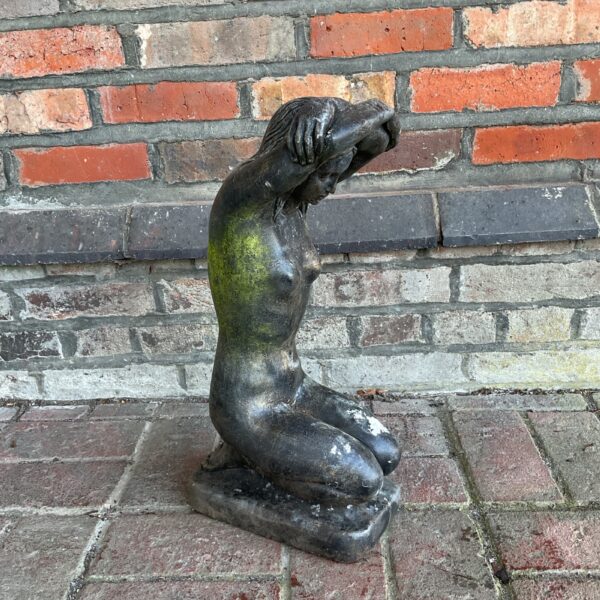 Vintage cast stone garden statue of a nude figure.