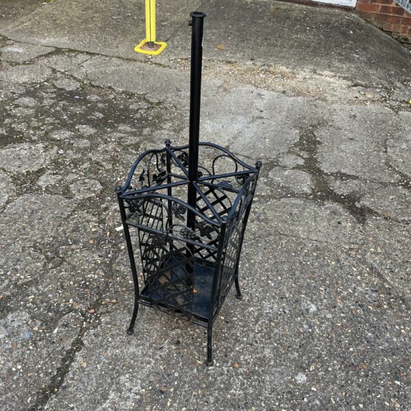 Decorative wrought iron garden parasol stand for outdoor use.