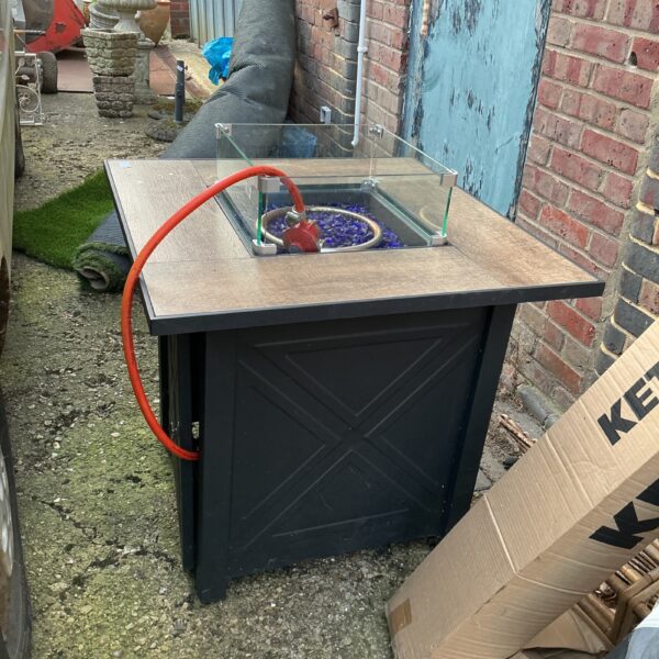 Garden patio heater table with fire pit and lava rocks.