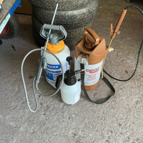 Lot of three handheld garden sprayers for plant care.