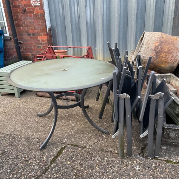 Large wrought iron garden table and chairs set for outdoor dining.
