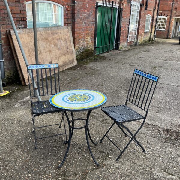 Vintage garden table and chairs set with tiled top.