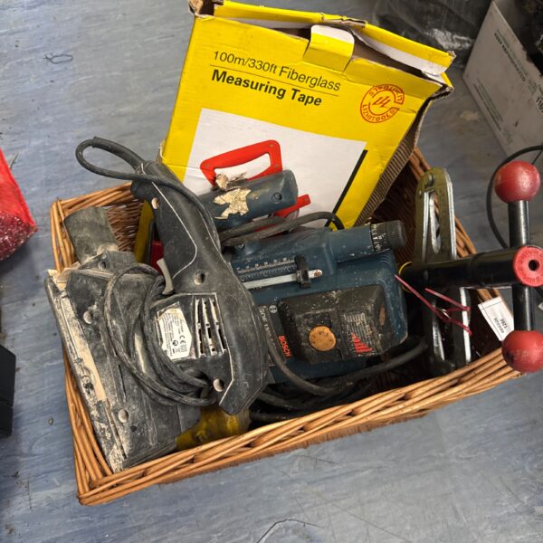 Basket of assorted garden and DIY tools for sale.