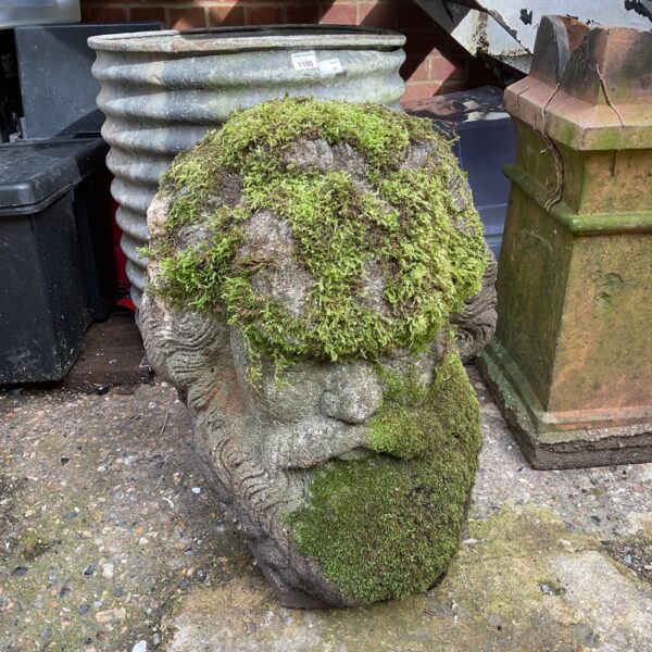 Weathered cast stone garden Zeus bust for outdoor display.